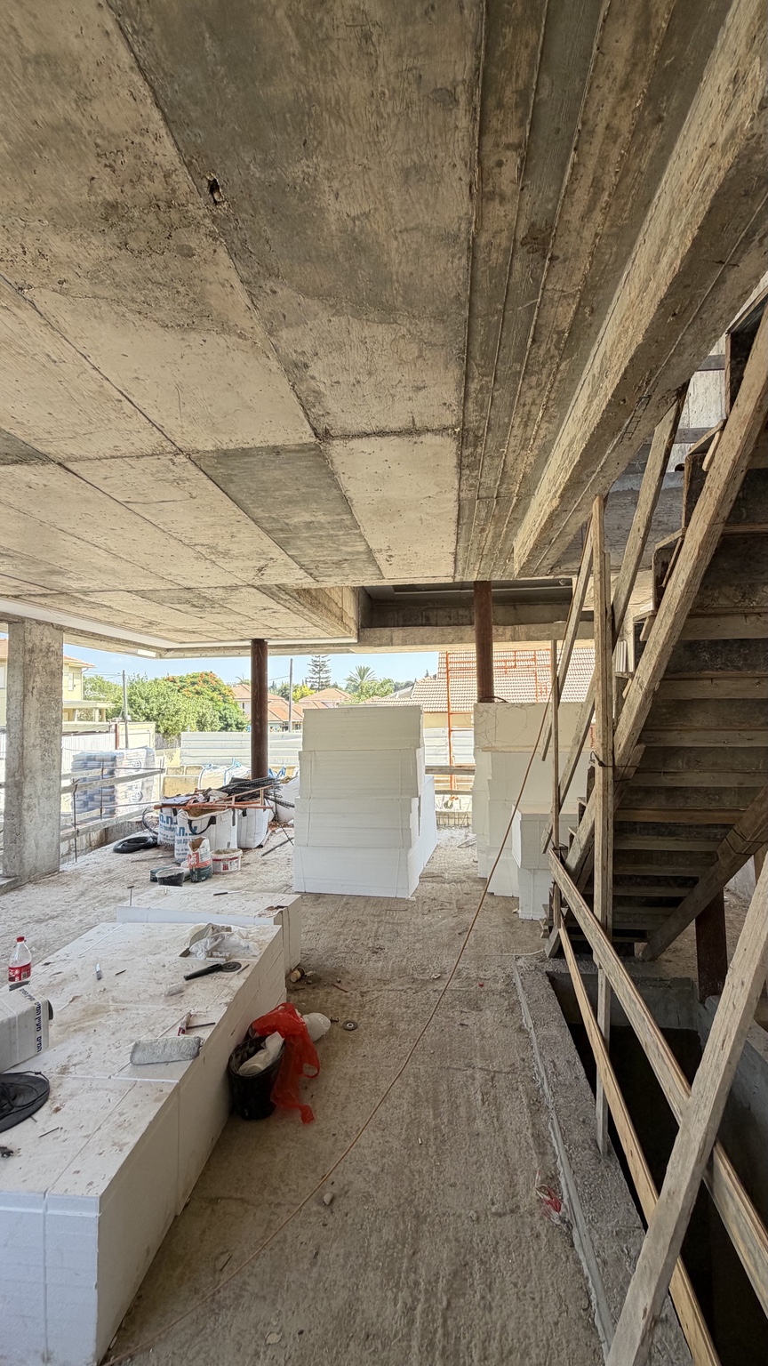 Open-plan interior and staircase under construction